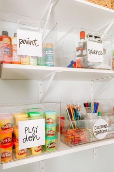 the shelves are filled with different types of paint and art supplies for kids to use
