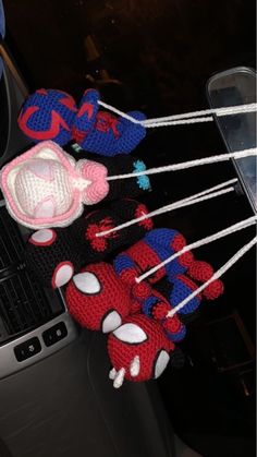 the spiderman hat and mittens are on display in front of an open car door