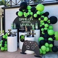 a video game themed party with black and green balloons