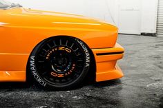 an orange sports car parked in a garage