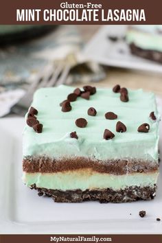 a piece of cake on a plate with chocolate chips and mint green frosting in the middle