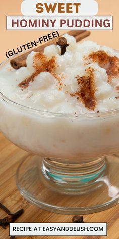 a bowl filled with pudding sitting on top of a wooden table next to cinnamon sticks