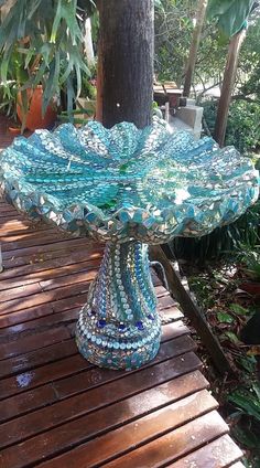 a blue glass bowl sitting on top of a wooden table