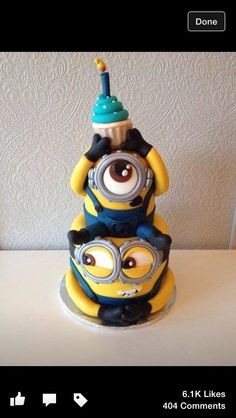 a birthday cake made to look like a minion sitting on top of another one