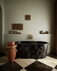 a bath tub sitting on top of a checkered floor