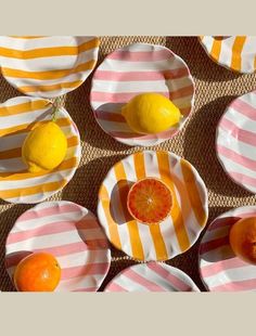 several plates with oranges and lemons on them are arranged in a grid pattern