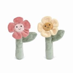 two stuffed flowers sitting on top of each other