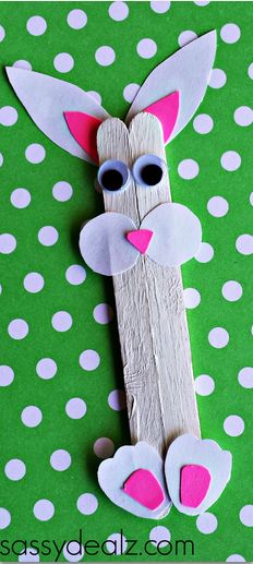 an easter bunny made out of popsicle sticks on a green background with white polka dots