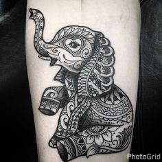 an elephant tattoo design on the right arm and leg, with intricate details in black ink