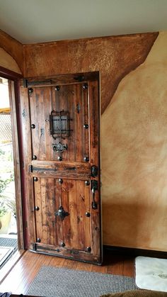 an old wooden door is in the corner of a room