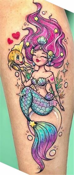 a girl with pink hair and a mermaid tattoo on her thigh
