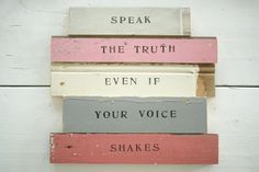 a stack of wooden signs with words written on them in different colors and sizes, including the word speak the truth even if your voice shakes