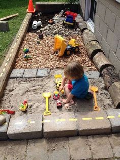 a toddler playing with toys in the yard