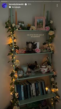 a shelf filled with lots of books covered in flowers and greenery next to a wall