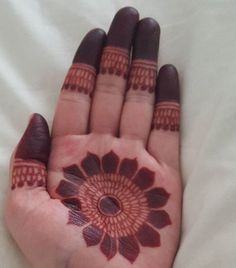 a woman's hand with henna tattoos on it