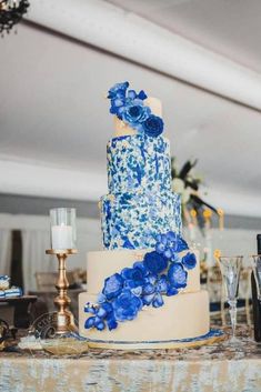 a wedding cake with blue flowers on it