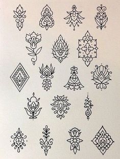 a bunch of black and white designs on a sheet of paper with some ink in it