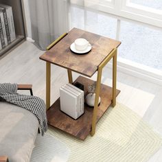 a small wooden table with a white plate and cup on it next to a couch