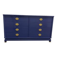 a blue dresser with gold knobs on it