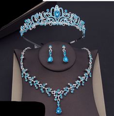 SPECIFICATIONS Rhinestone crystal crown, necklace, earring sets in several colors featuring a petite crown with hair comb ends with a matching necklace with pendant and dangle drop matching earrings. material: rhinestone crystal, metal type: girls crown set crown, necklace, earrings colors: as shown Quinceañera Jewelry, Tiara Jewelry, Blue Necklace Set, Quinceanera Jewelry, Crystal Comb, Blue Quince, Tiaras Jewellery, Crown Set, Crystal Bridal Tiaras