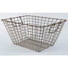 a metal basket that is sitting on a white surface with the handle extended to it's side