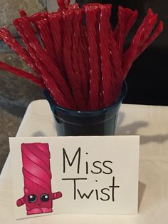 red sticks in a glass with a sign that says miss twist