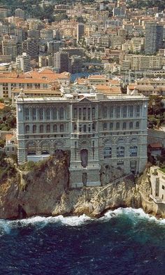 an aerial view of a large building on top of a cliff next to the ocean