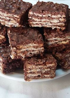 a white plate topped with chocolate brownies on top of a table