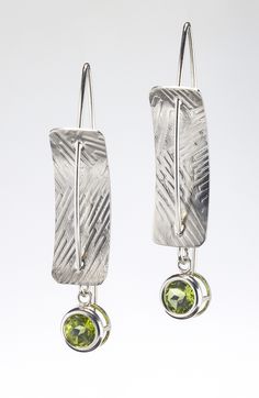 Silver & Stone Earrings - Sterling silver, concave, rectangular earrings pierced by sterling silver ear wires.  A 6mm-round, faceted peridot is bezel-set and dangles from the bottom of the earrings. The sterling-silver rectangles are textured with roller printing. Each pair of earrings is handmade; the texture will vary. Pmc Earrings, Roller Printing, Solder Jewelry, Printed Texture, Handmade Silver Earrings, Sterling Silver Earrings Handmade, Rectangular Earrings, Tin Earrings, Earring Inspiration