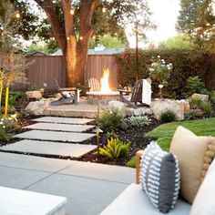 an outdoor patio with fire pit and seating area