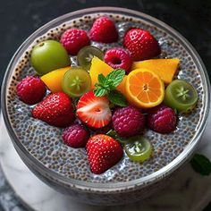 a glass filled with fruit on top of a table