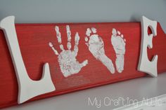 a red sign with two hand prints on it