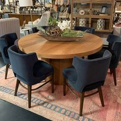 a round table with blue chairs around it