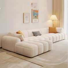 a large white couch sitting in a living room next to a window