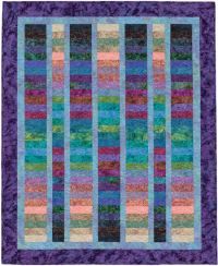 a quilted wall hanging with multicolored stripes