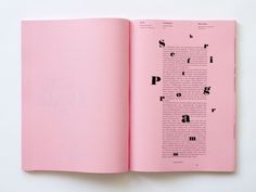 an open pink book with black letters on it