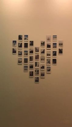 a wall with many pictures hanging on it