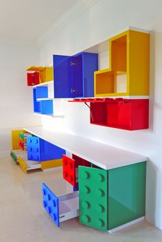 colorful legos are stacked on top of each other in a room with white walls