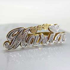 two gold and silver name rings with hearts