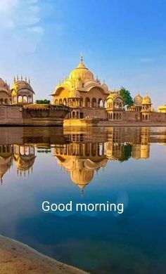 an image of a beautiful view of the water and some buildings with yellow domes on them