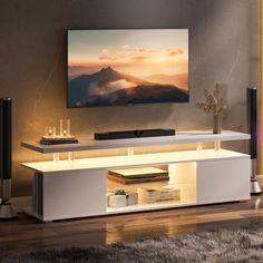 a flat screen tv sitting on top of a white entertainment center in a living room