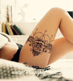 a woman laying on top of a bed next to a book shelf