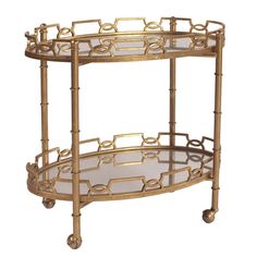 two tiered gold metal serving cart with glass shelves