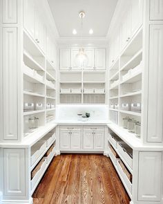 a kitchen with white cabinets and wood flooring is pictured in this image from the inside