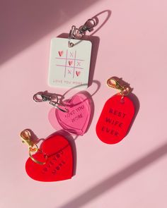 three heart shaped keychains with the words best wife ever written on them, sitting next to each other
