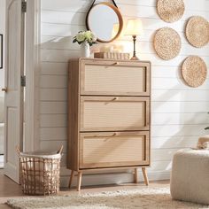 a white room with wicker furniture and decor on the walls, including a round mirror