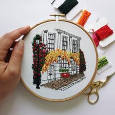 someone is stitching an embroidery project with scissors