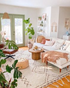 a living room filled with furniture and plants