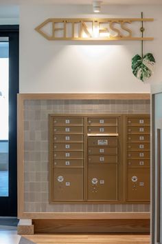 a wall mounted mailbox sitting next to a doorway