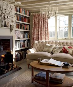 a living room with a couch, coffee table and bookshelf filled with books